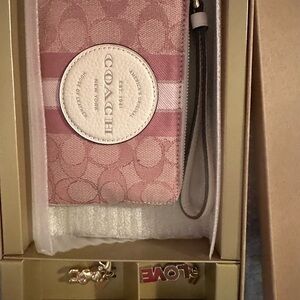Limited edition Coach wristlet with two charms/keychains. NWT